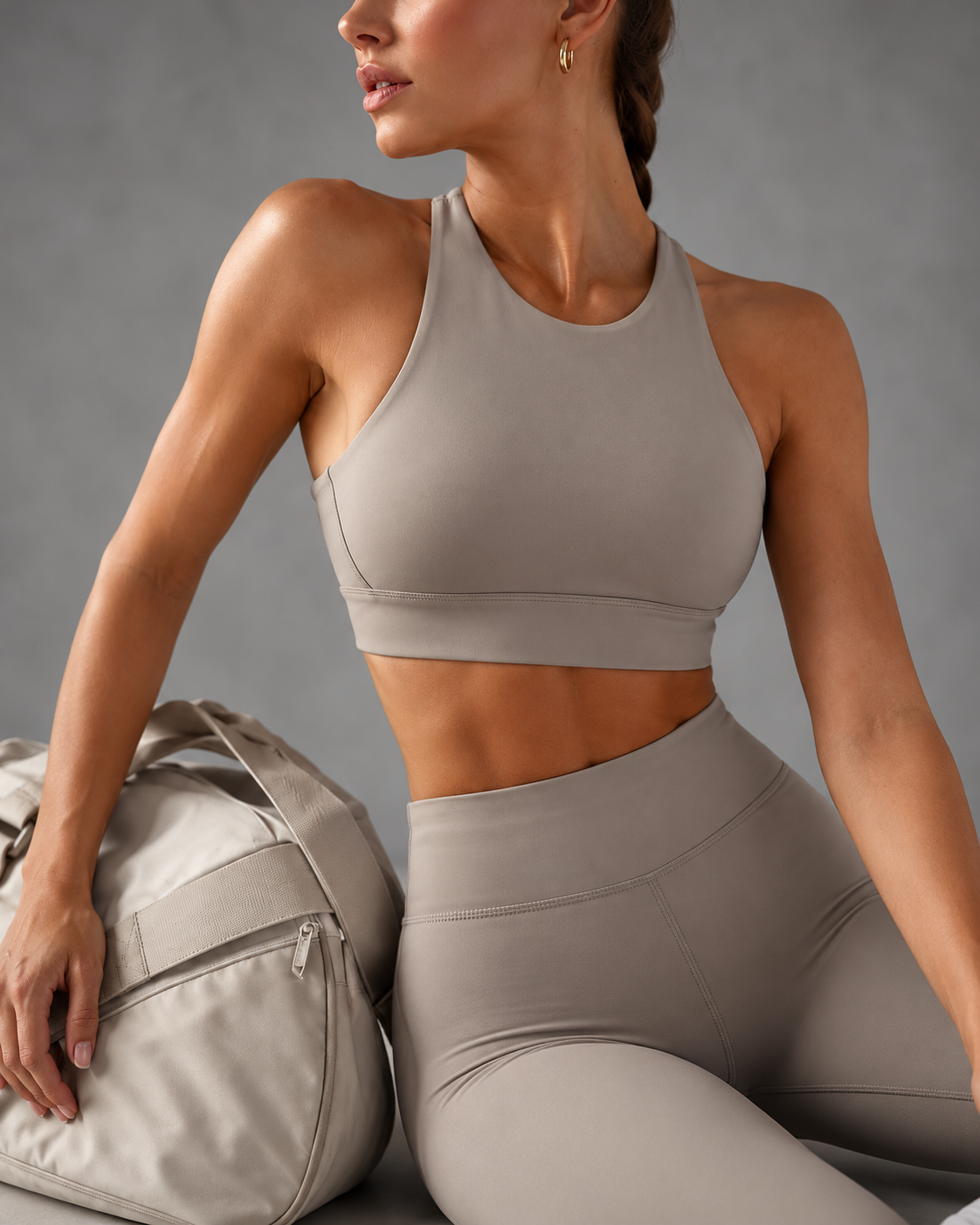 Athlete in a matching NERVE sports bra and leggings set beside a gym bag
